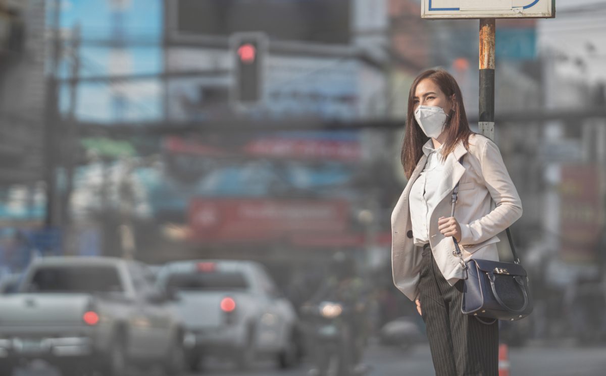 Woman wearing N95 mask for PM 2.5 city air pollution